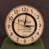 Round oak clock with music notes and the words, "If music be the food of love, play on" lasered on face - 8" on easel