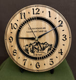 Round oak clock with a mountain and the words, "The mountains are calling and I must go" lasered in the face - 8" on easel