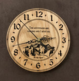 Round oak clock with a mountain and the words, "The mountains are calling and I must go" lasered in the face - 6.5" size