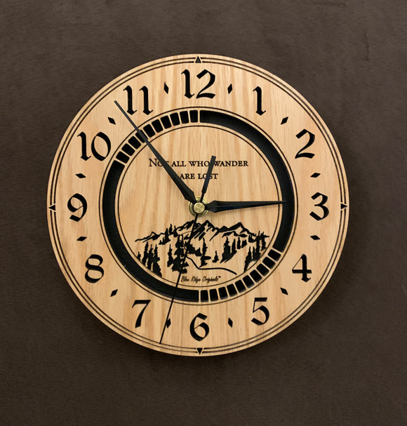 Round Oak clock with a mountain and the words, 