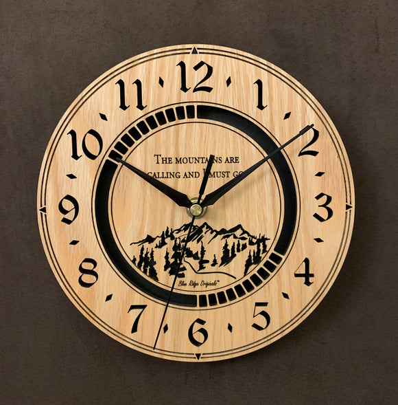 Round oak clock with a mountain and the words, 
