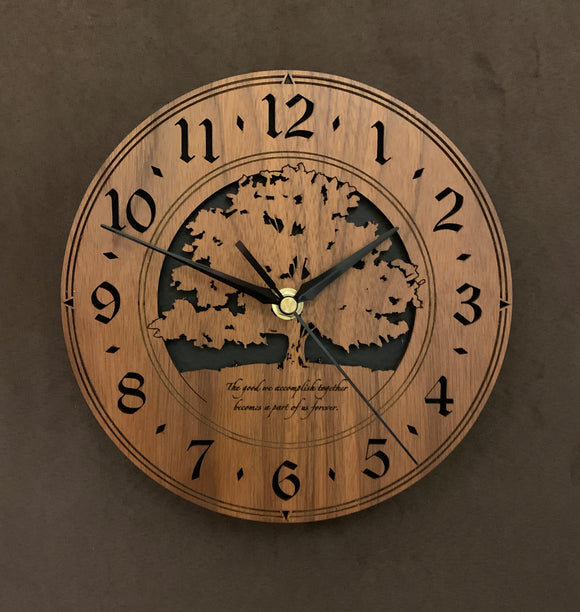 Round walnut clock with a tree and the words, 