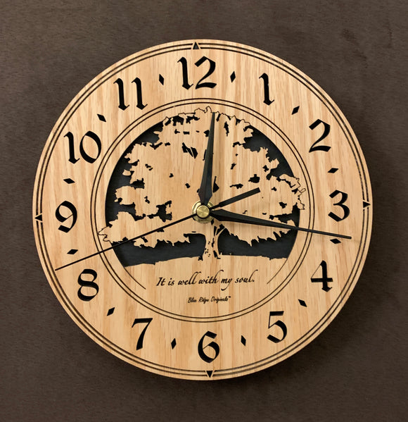 Round oak clock with a tree and the words, 