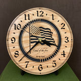 Round oak clock with a lasered American flag and black background with the words "Land of the free"  - 8" on easel