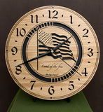 Round oak clock with a lasered American flag and black background with the words "Land of the free"  - 11.3" on easel