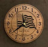 6.5" Round Walnut clock with a laser-cut flag in the middle, the words, "Land of the Free" beneath it, and the numbers 1-12 cut through around the perimeter.