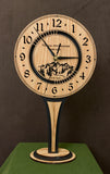 Round Oak clock with a mountain and the words, "Not all who wander are lost" lasered in the face - 8" on tall stand