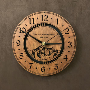 Round walnut clock with a mountain and the words, "Not all who wander are lost" lasered in the face - larger sizes