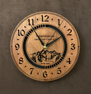 Round walnut clock with a mountain and the words, "The mountains are calling and I must go" lasered in the face - larger sizes