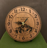 Round walnut clock with a mountain and the words, "Not all who wander are lost" lasered in the face - 6.5" size on easel
