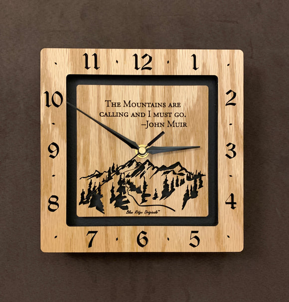 A square oak clock with the numbers on the outer square section, while on the inner square section a mountain and the words, 