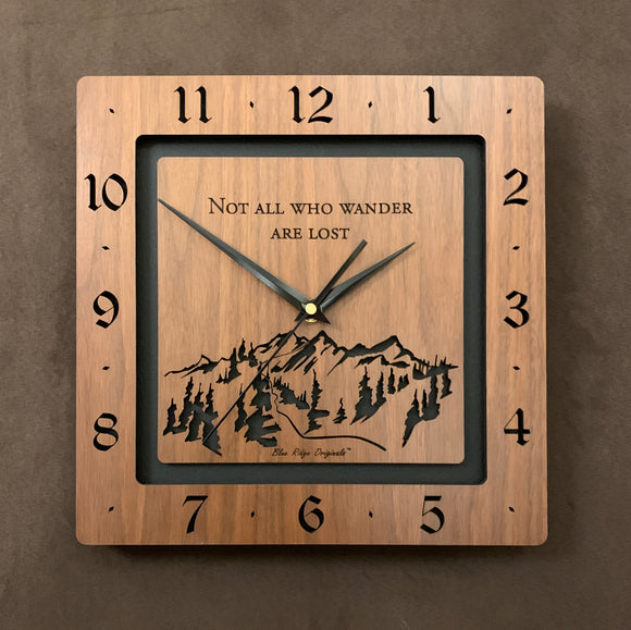 A square walnut clock with the numbers on the outer square section, while on the inner square section a mountain and the words, 