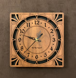 A square walnut clock with cutouts forming a patterned circle around the face and numbers of the clock and cutout flourishes in the corners. Somewhat in an Art Deco style. 8" Size