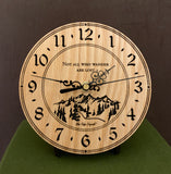 Round Oak clock with a mountain and the words, "Not all who wander are lost" lasered in the face - 6.5" on easel