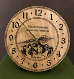 Round oak clock with a mountain and the words, "The mountains are calling and I must go" lasered in the face - 6.5" on easel