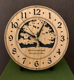 Round oak clock with a tree and the words, "The good we accomplish together becomes a part of us forever" lasered on face - 8" on easel