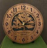 Walnut clock with lasered tree and small bird, with the words, "Family gives us roots and wings" - on easel