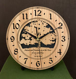 Round oak clock with a tree and the words, "Patience and persistence are at the heart of every good thing" lasered on face - 8" on easel