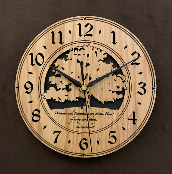 Round oak clock with a tree and the words, 