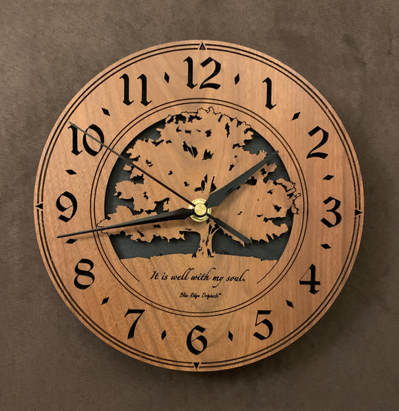 Round walnut clock with a tree and the words, 