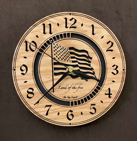 Round oak clock with a lasered American flag and black background with the words 