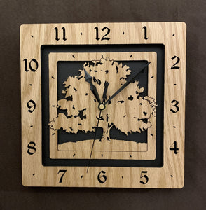 A square oak clock with the numbers on the outer square section, while a tree is lasered into the inner square section. The concentric wood squares have a gap between them and are set against a black background.
